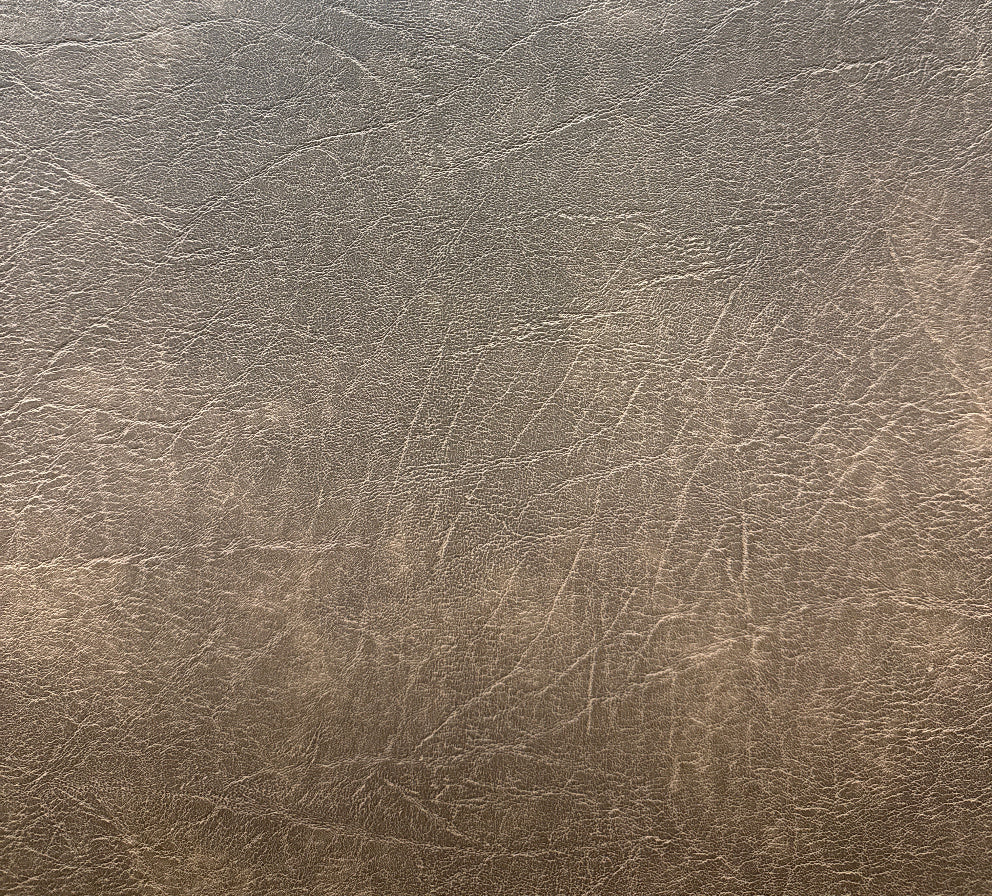 A close-up image of a textured, metallic fabric with a grainy appearance, likely used for upholstery purposes.