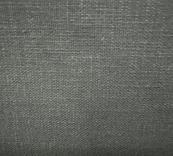 Close-up of a textured fabric with a solid pattern and slight sheen.
