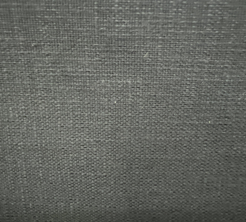Close-up of a textured fabric with a solid pattern and slight sheen.