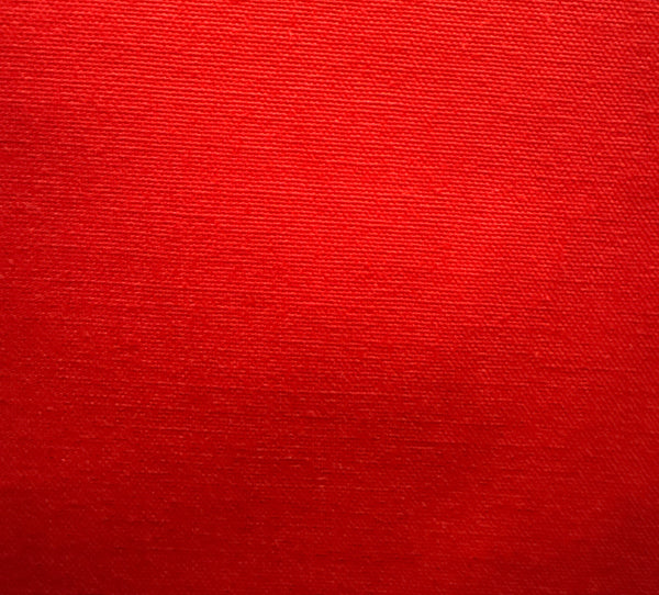 Close-up of a red textured fabric, likely a part of a slipcover or upholstery.