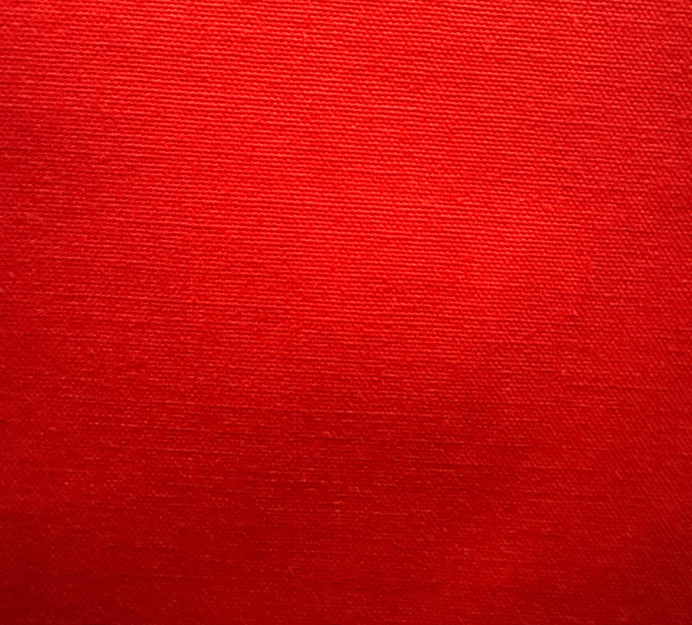Close-up of a red textured fabric, likely a part of a slipcover or upholstery.