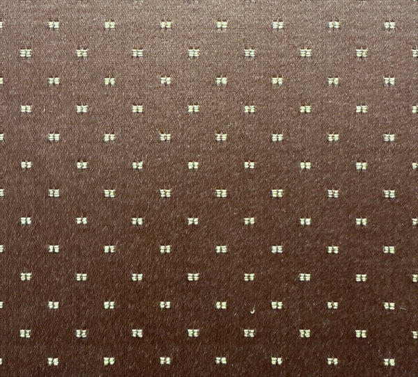 Brown fabric with a subtle pattern of small white shapes