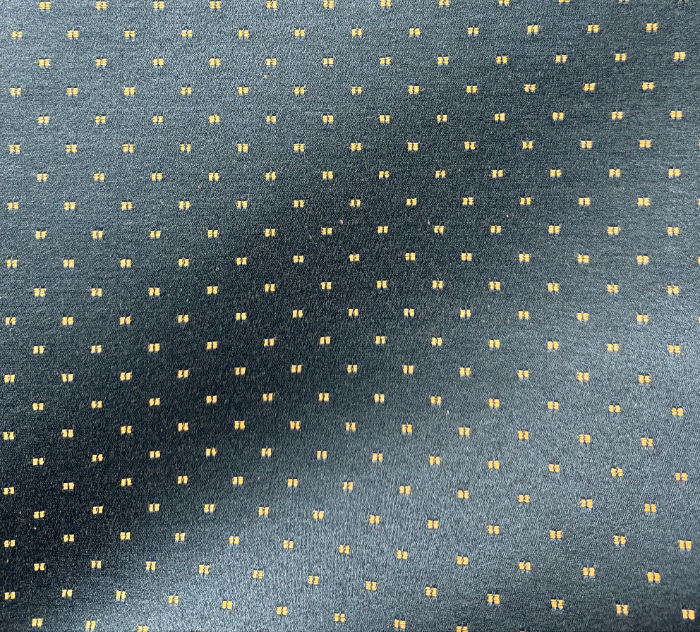 Patterned fabric with small yellow squares on a blue background