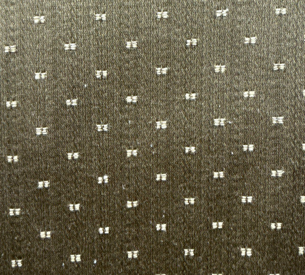 A close-up image of a textured fabric with a dotted pattern.