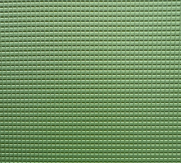 Close-up of a green, solid-colored vinyl upholstery fabric.