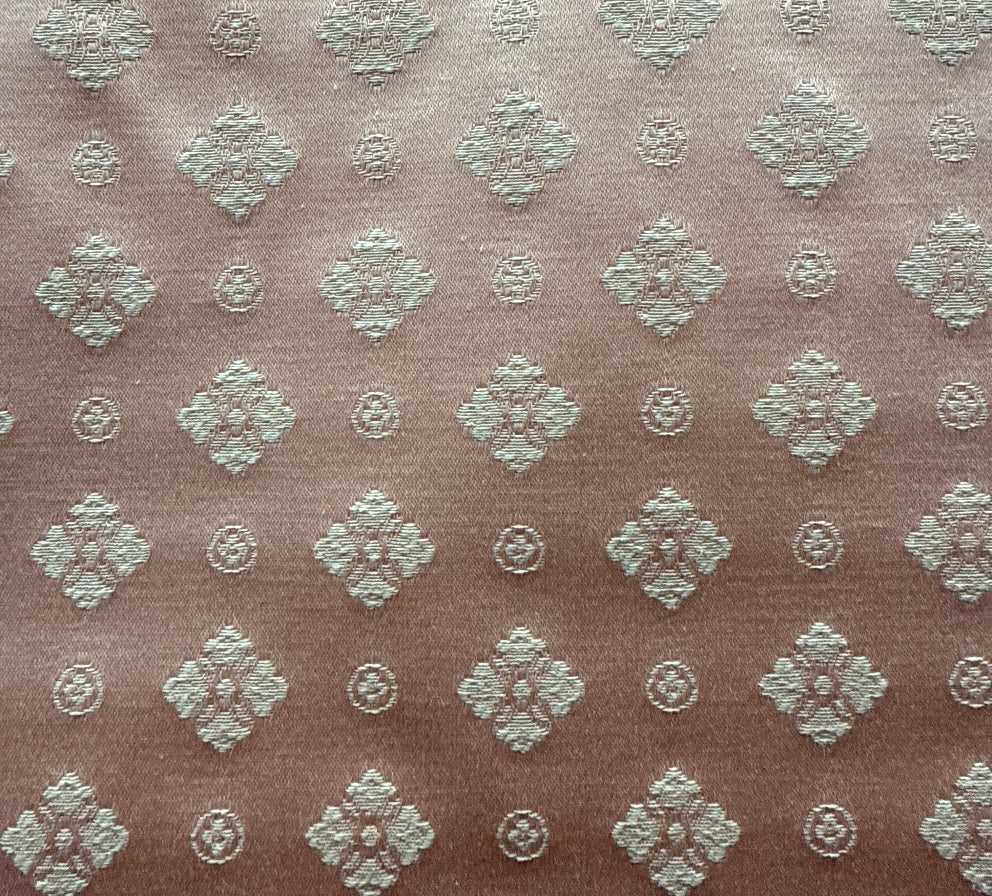 Textured fabric with diamond pattern on a brown background