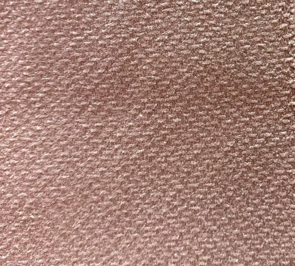 A close-up texture shot of a fabric with a leaf-like pattern.
