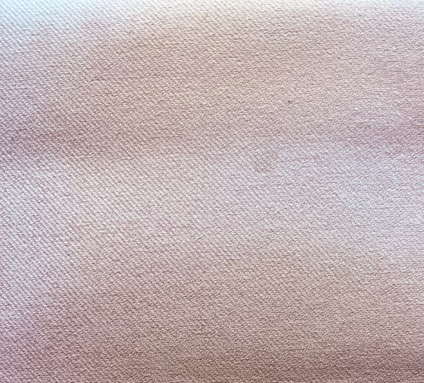 Close-up of a beige cotton upholstery drapery pillow texture.