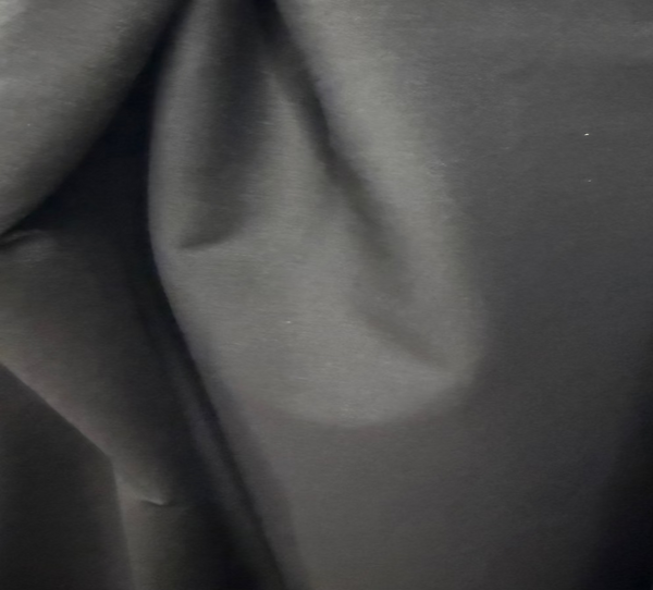 Close-up of gray fabric with a visible stain.