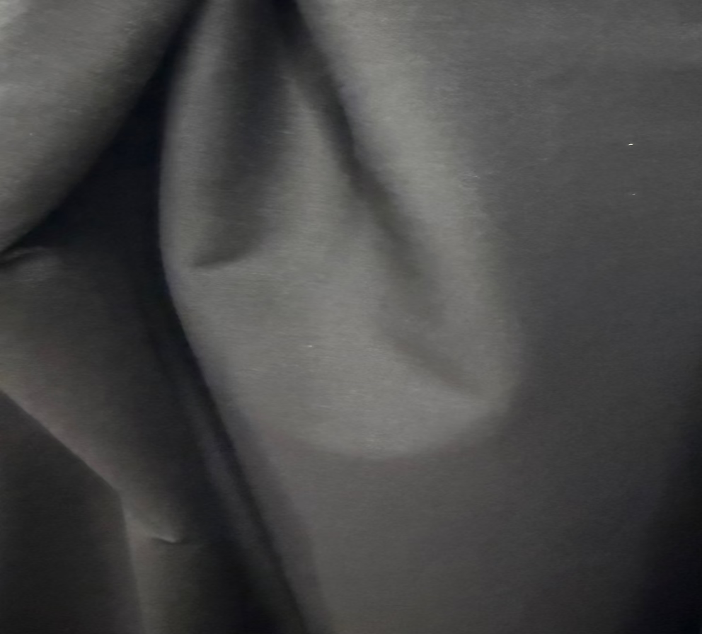 Close-up of gray fabric with a visible stain.