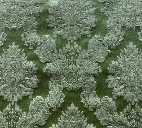 Decorative fabric with intricate floral patterns on a green background