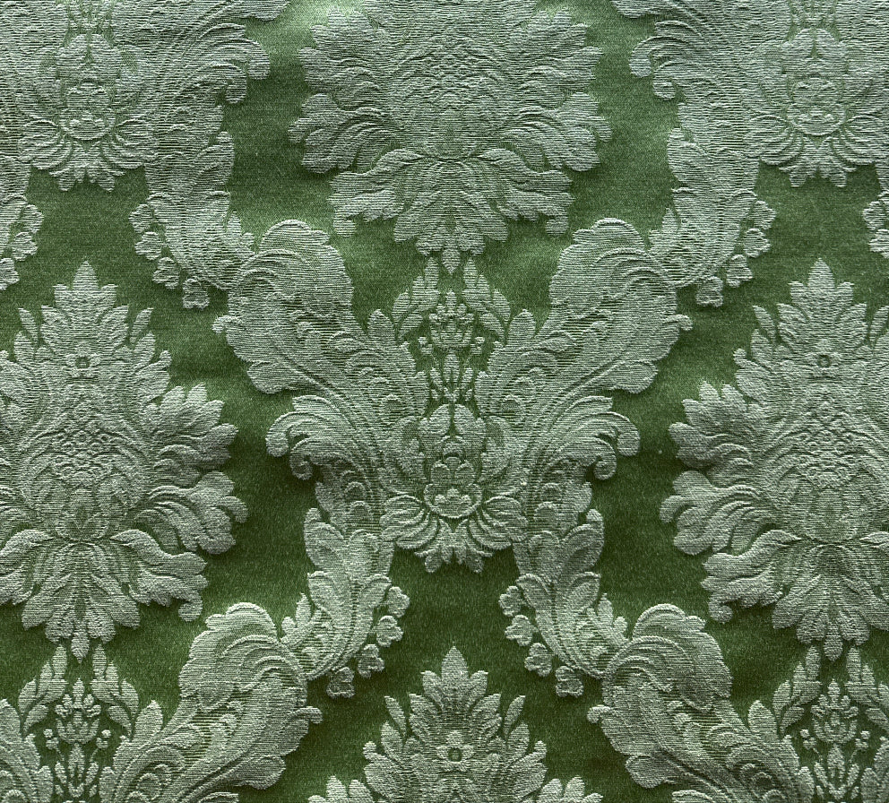 Decorative fabric with intricate floral patterns on a green background