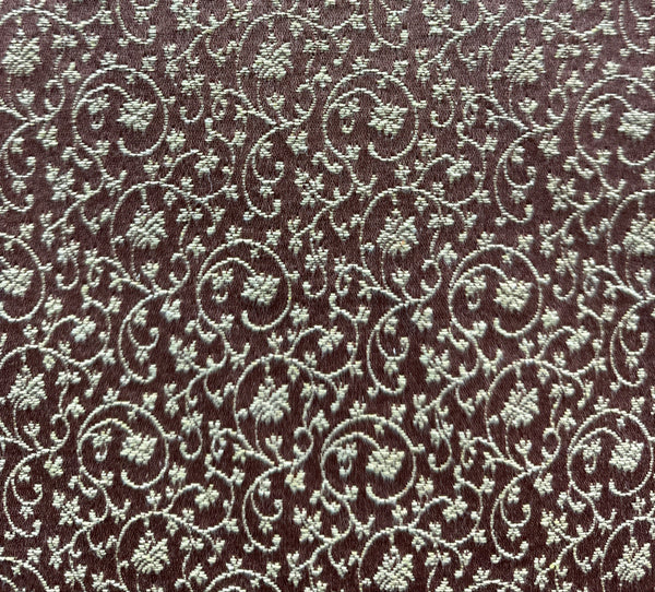 Textured fabric with intricate pattern on a brown background