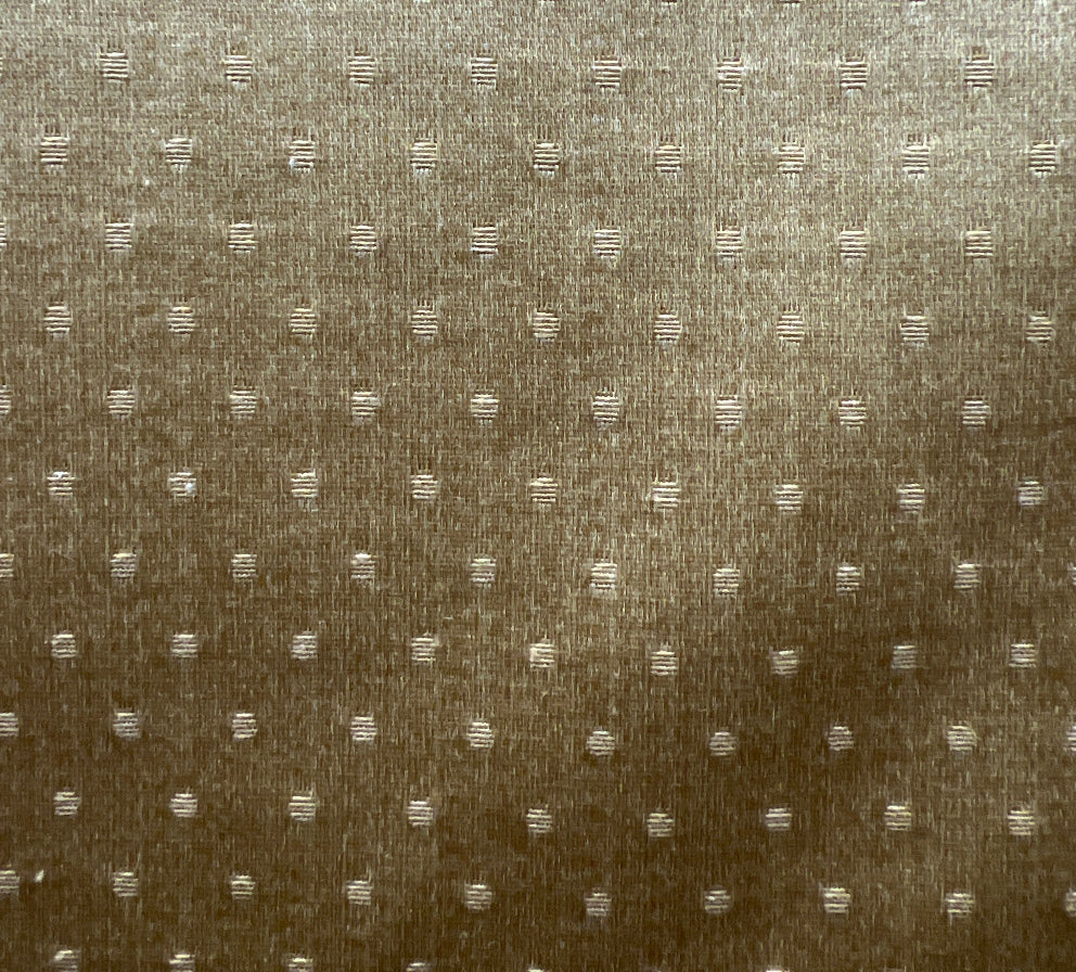 A fabric with a solid pattern, showing slight texture, predominantly beige or light brown in color.