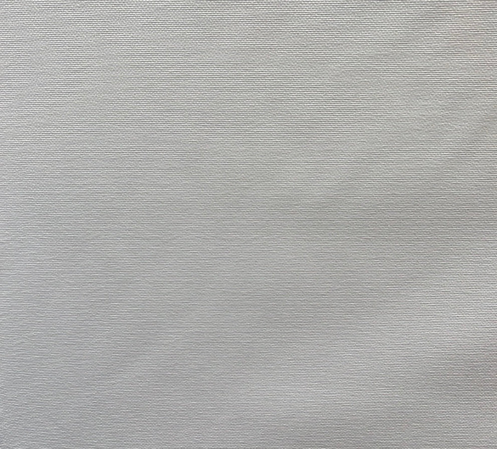A plain textured white fabric, likely to be a close-up of the upholstery slipcover material.