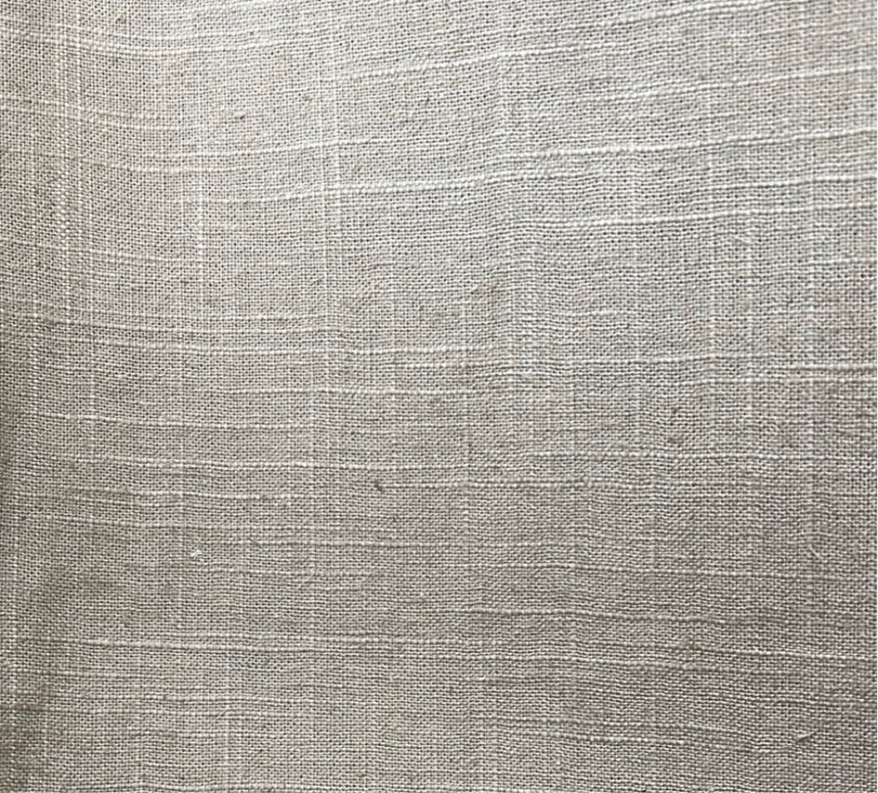 Close-up texture shot of a beige cotton-linen blend fabric.